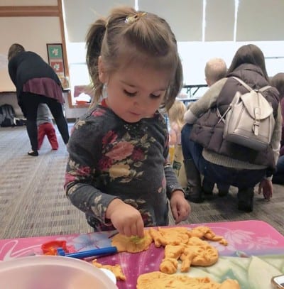 little girl playing at geauga county library event
