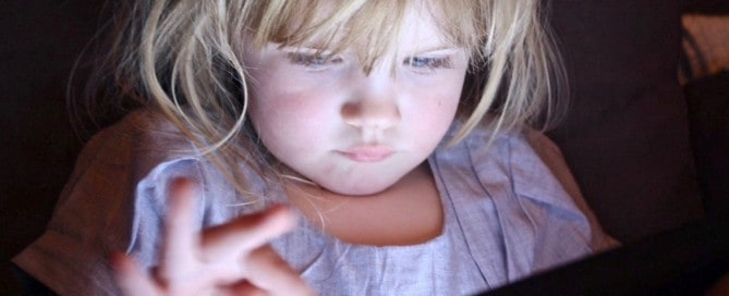 child playing on tablet