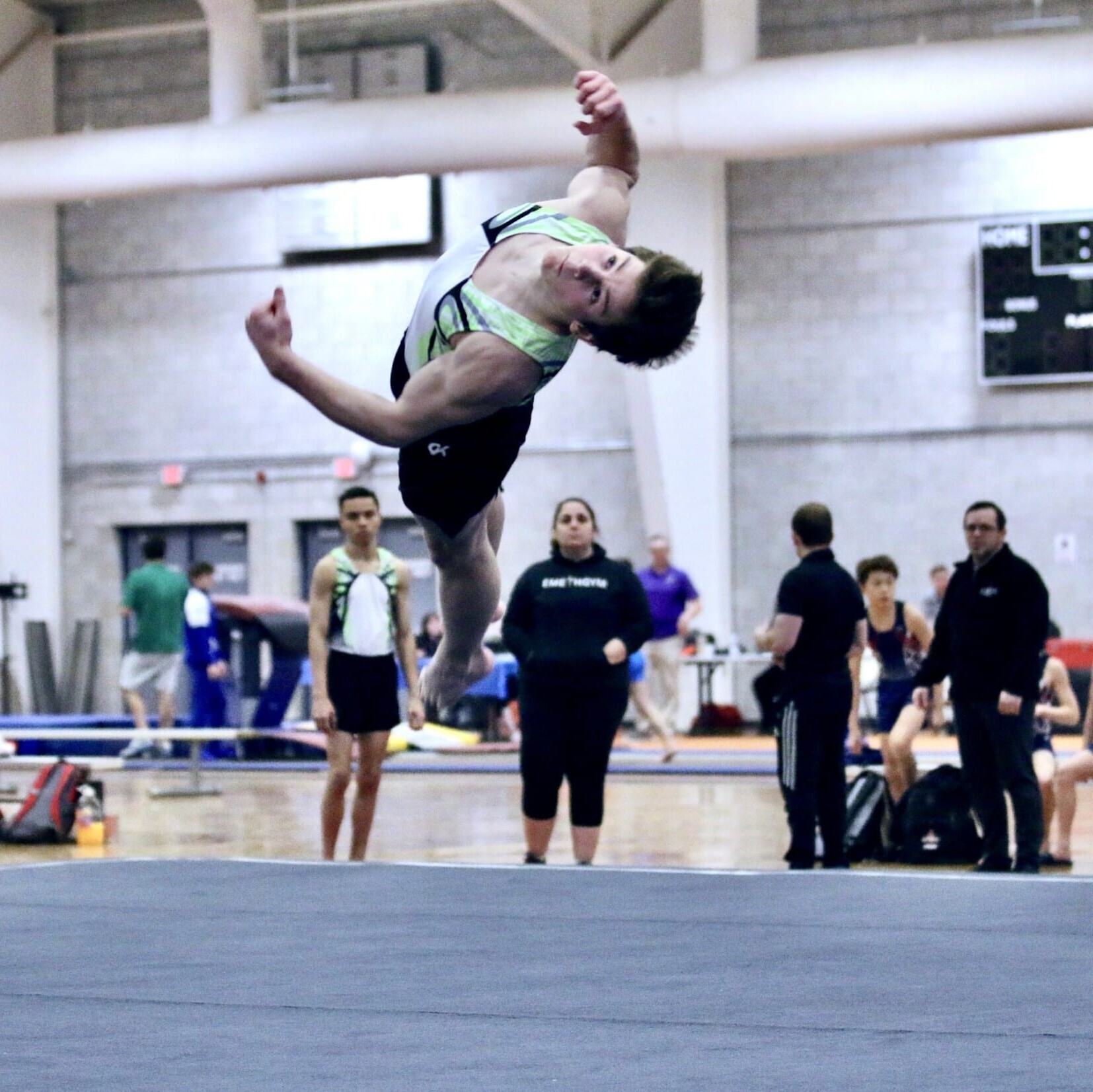 Boy entering full twist tumbling skill on floor Boy entering full twist tumbling skill on floor
