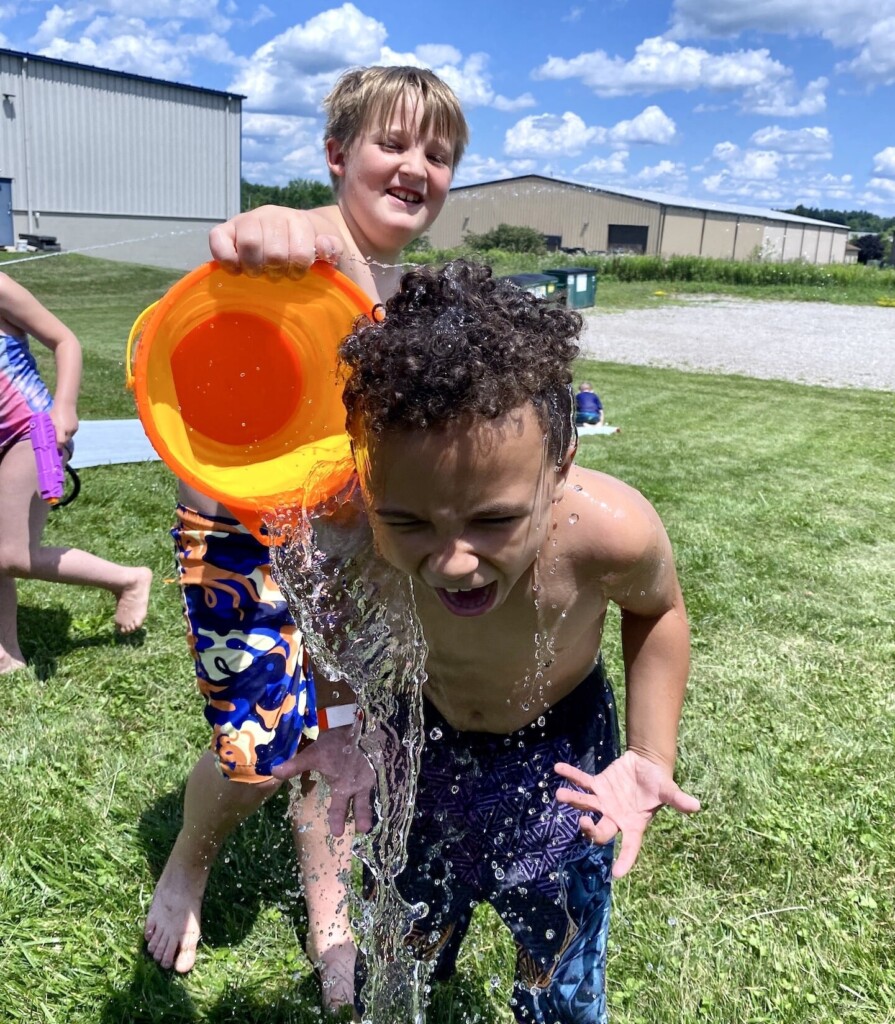 Two boys at Emeth fun camp playing water games
