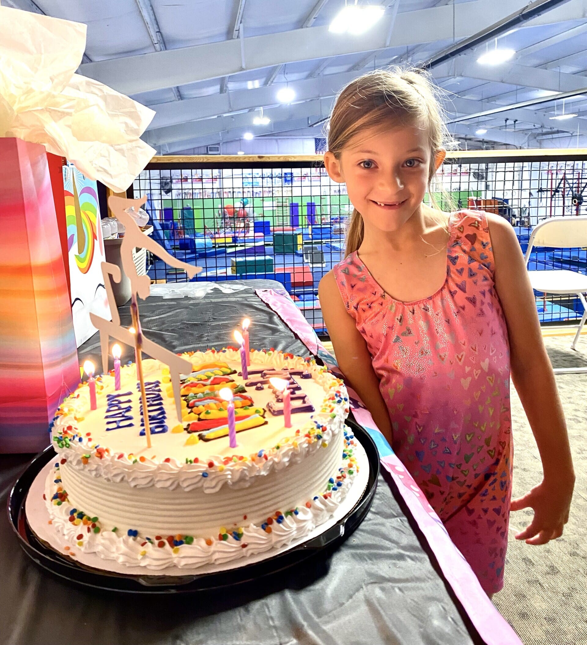 Girl next to cake at EmethGym birthday party Girl next to cake at Emeth birthday party