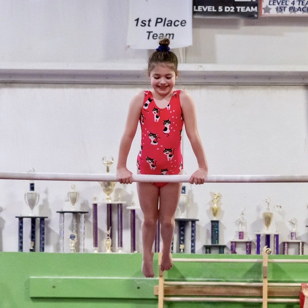 Girl on bars in gymnastics class Dawnlights