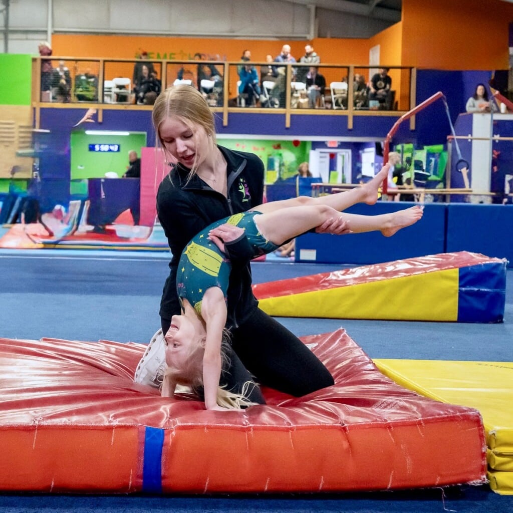 Girl with coach in tumbling class at EmethGym