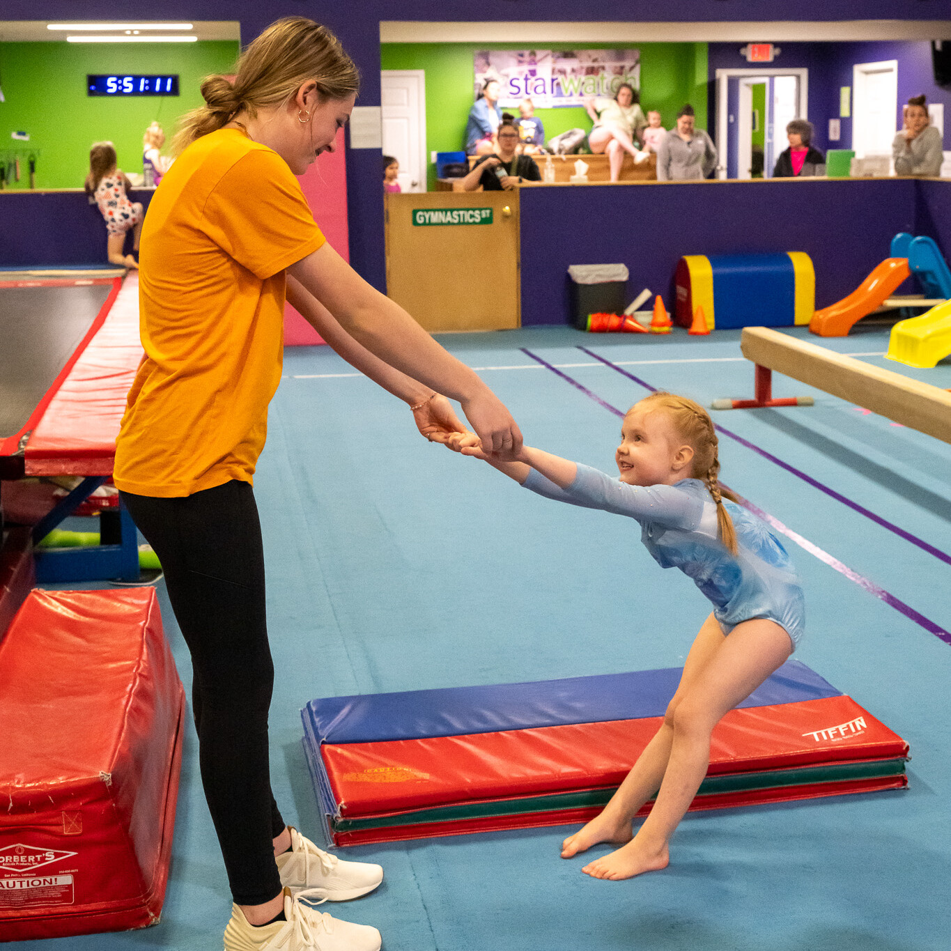 Preschool girl and coach having fun together in gymnastics class toddler / preschool gymnastics coach with boy on rings