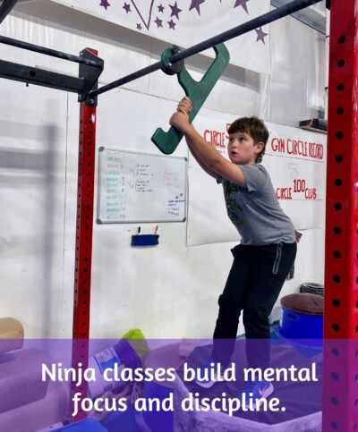Boy concentrating during ninja warrior class