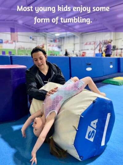 Student practicing tumbling in gymnastics class